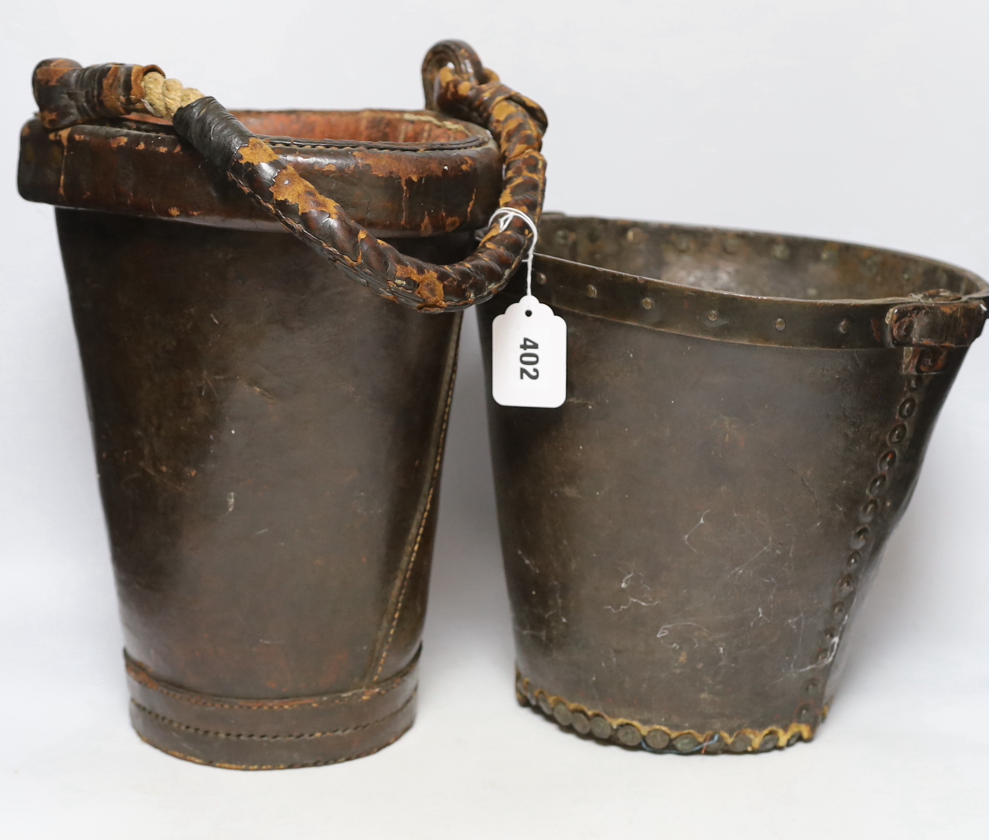 Two 19th century leather fire buckets, tallest 32.5cm